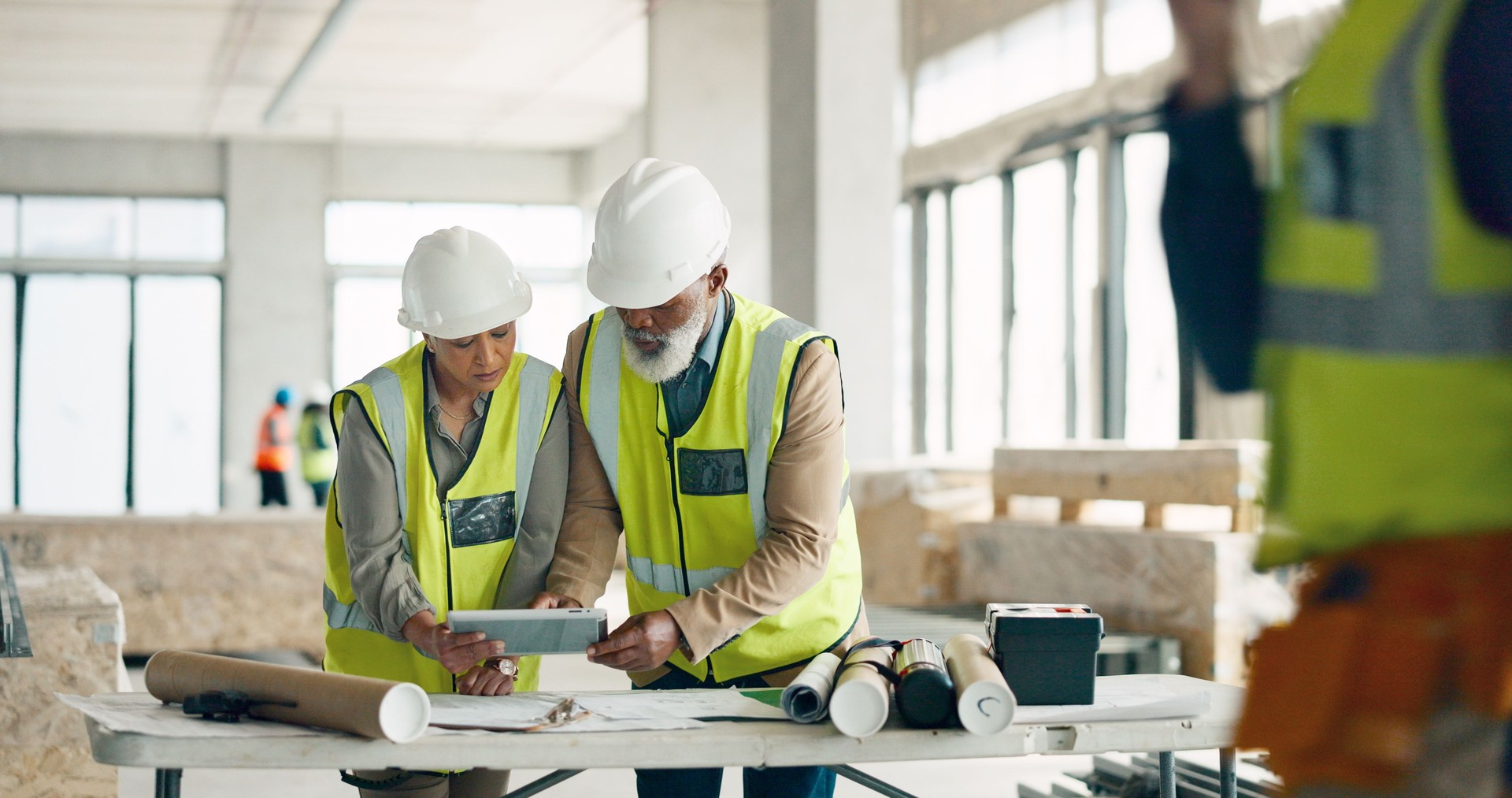 Construction, team and tablet with blueprint of building, architecture and maintenance software. Engineering, collaboration and digital tech for property, industrial floor plan and project management